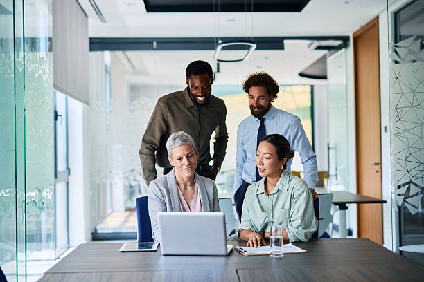 istock Business team collaborating on a project, looking at a laptop in the office 2219159286