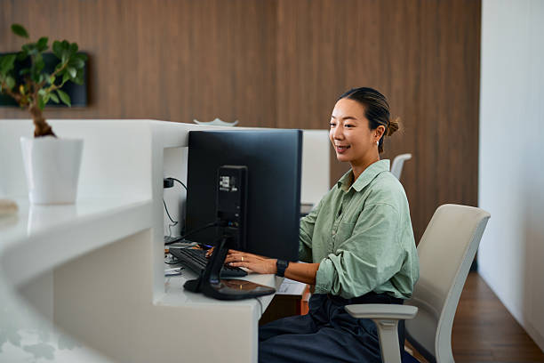 istock Young Asian businesswoman working on a computer in a modern office 2219159576