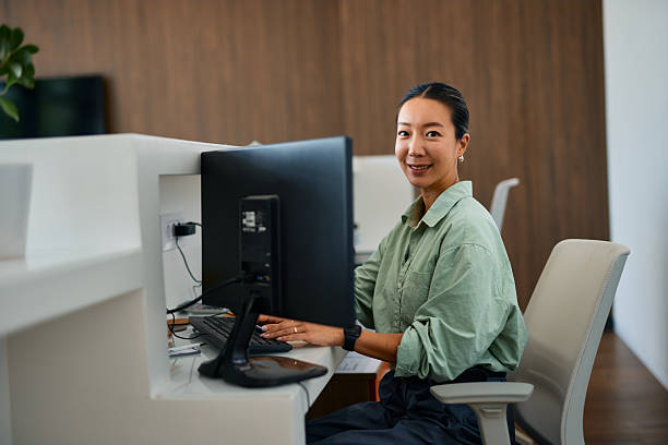 istock Young Asian businesswoman working on computer at modern office 2219159587