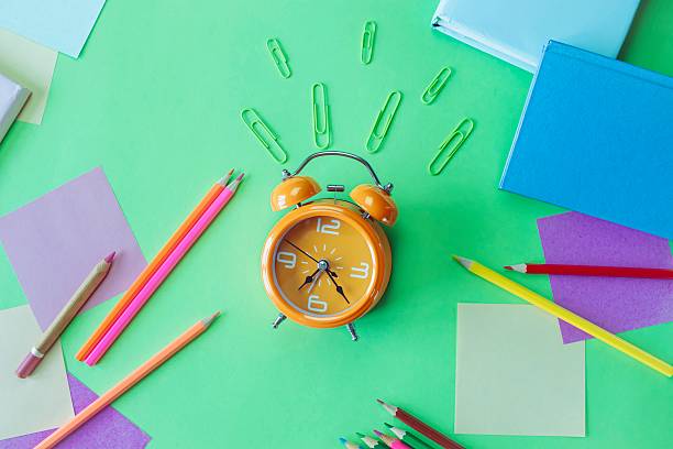 istock Alarm clock, school supplies and creative learning materials in pastel colors, back to school. 2219160845