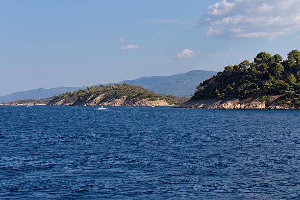 istock a coastline with lush greenery under a partly cloudy sky 2219163427