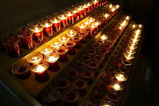istock Burning votive candles casting warm, flickering light within sacred church interior, symbolizing spiritual contemplation and quiet reverence 2219164605
