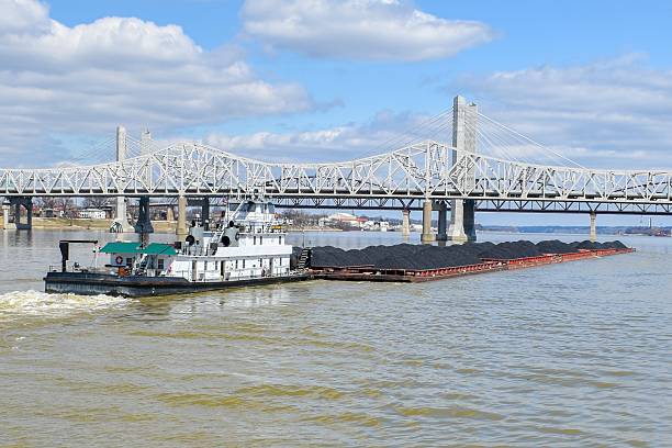 istock Tugboat pushing barges loaded with coal 2219165249