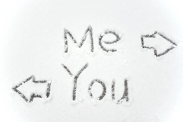 you and me text with arrow sign on snow