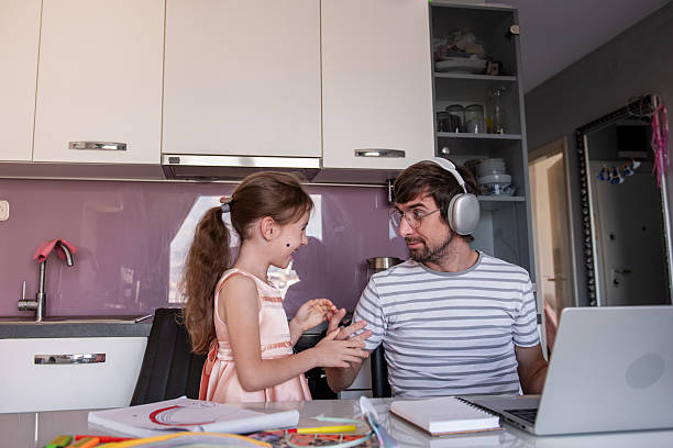 istock Father working from home struggling with his daughter interrupting him 2219167442