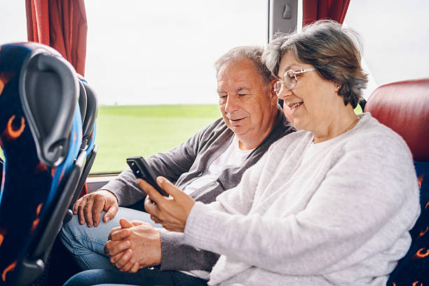 istock Couple using phone in bus. Traveling concept 2219167479