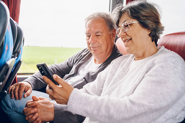 istock Couple using phone in bus. Traveling concept 2219167489