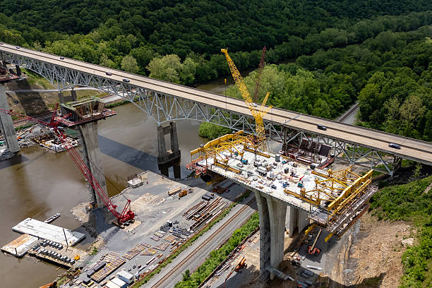 istock Construction site at New York road bridge from above, cranes and workers busy. 2219168464