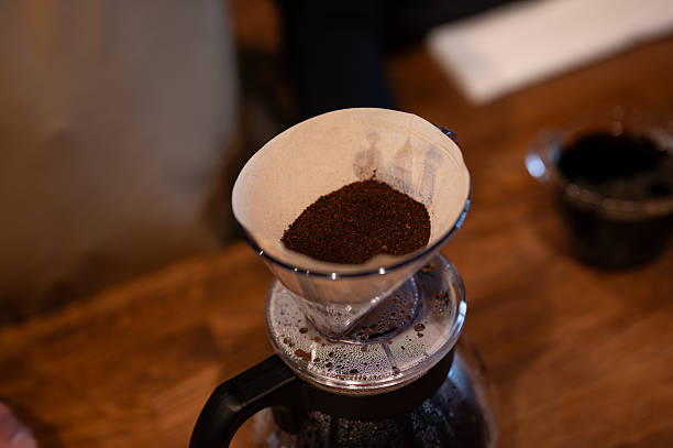istock Coffee filter and ground coffee beans inside the dripper. 2219171408