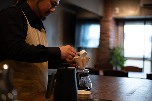 istock A male barista putting coffee beans into a dripper. 2219171457
