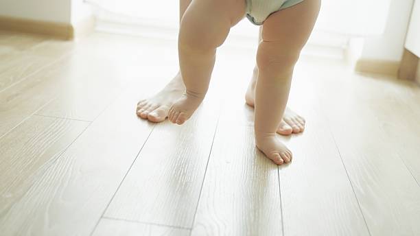 istock Mother teaches baby to walk. 2219178916