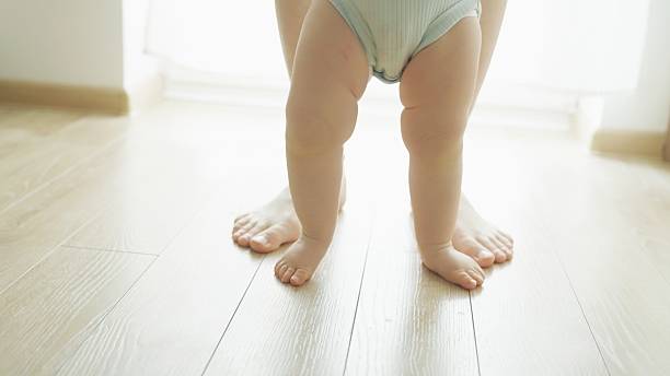 istock Mother teaches baby to walk. 2219178921