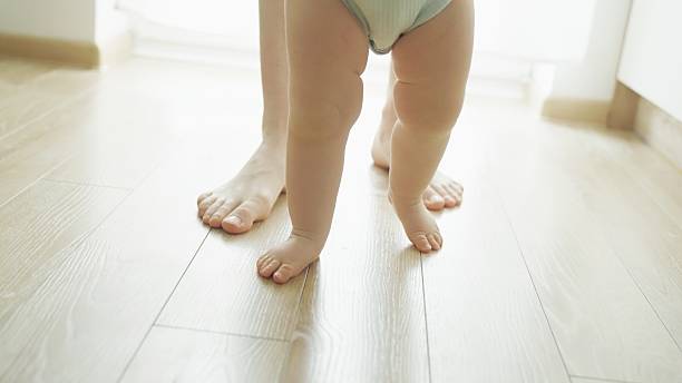 istock Mother teaches baby to walk. 2219178925