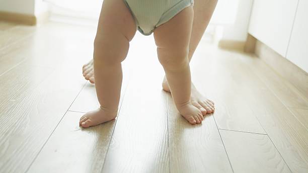 istock Mother teaches baby to walk. 2219178929