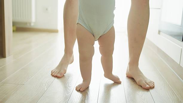 istock Mother teaches baby to walk. 2219178937