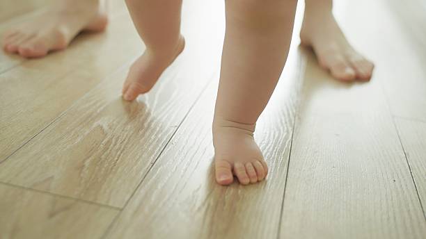 istock Mother teaches baby to walk. 2219178946