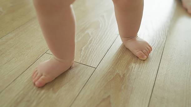 istock Mother teaches baby to walk. 2219178948