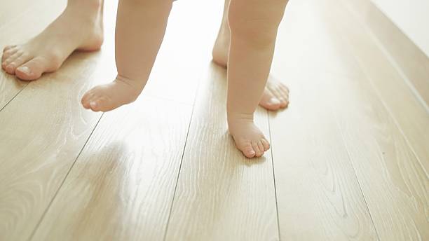 istock Mother teaches baby to walk. 2219178962