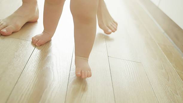 istock Mother teaches baby to walk. 2219178972