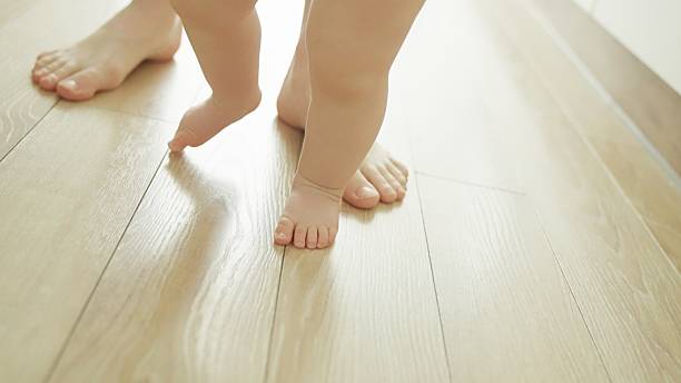istock Mother teaches baby to walk. 2219178974