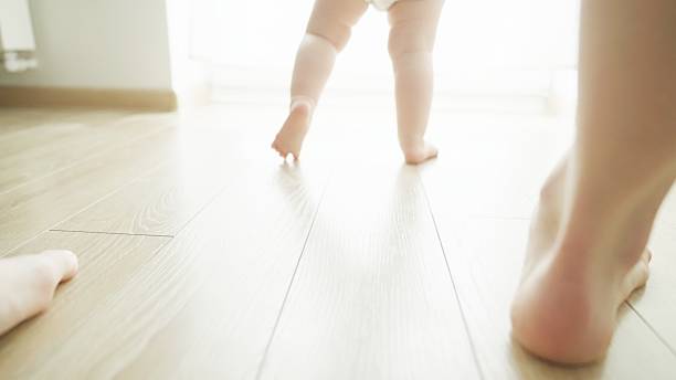 istock Mother teaches baby to walk. 2219178978