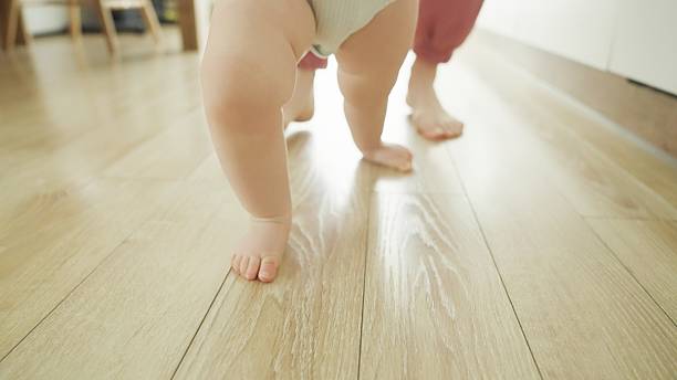 istock Mother teaches baby to walk. 2219178981