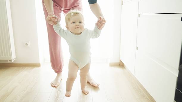 istock Mother teaches baby to walk. 2219178987