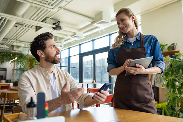 istock Man discussing order with waiter at restaurant 2219181946
