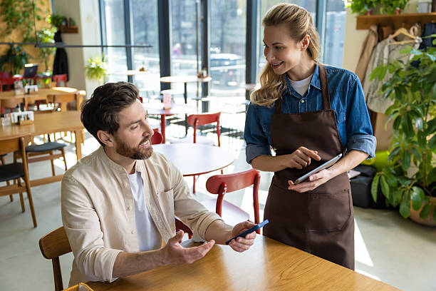 istock Waiter entering order on tablet at restaurant 2219181948