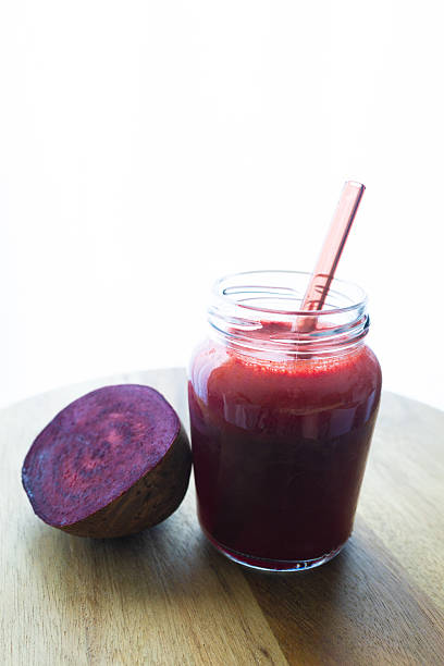 A vibrant beetroot smoothie served in a clear glass, showcasing its deep red color and thick texture. Known for its antioxidant, anti-inflammatory, and blood pressuresupporting benefits, this drink is perfect for health and wellness content.