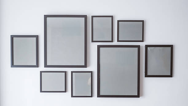 istock Modern arrangement of empty picture frames on a white wall, suitable for use in mockup presentations, interior design templates, and product advertising. 2219187859