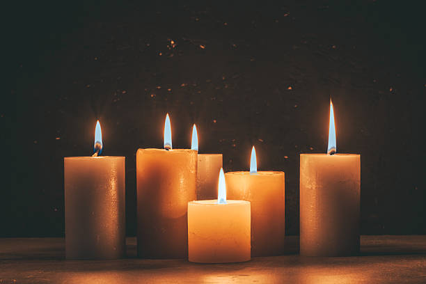 istock Candles burning on wooden table in front dark background. 2219188741