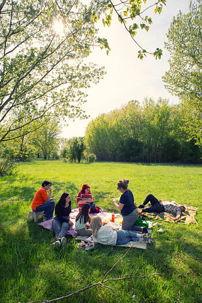 Family of seven having fun on the picnic in nature