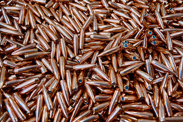 istock Glowing large caliber bullet heap for riffle as background 2219191836