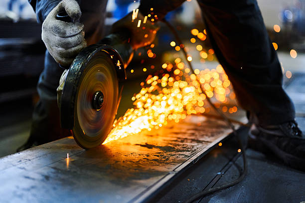 istock Metal plate cutting with abrasive disk and splashing sparks 2219191850