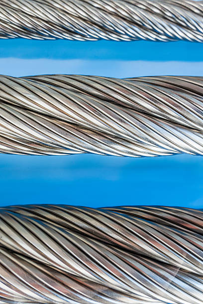 istock Twisted metal cables arranged in parallel, showcasing detailed craftsmanship and robust construction at a workshop in the early afternoon 2219191869
