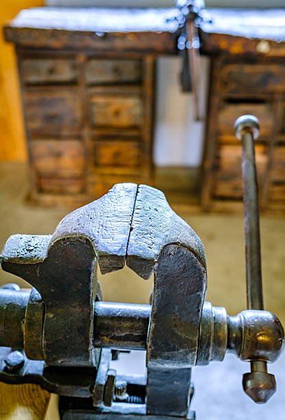istock Vintage woodworking vise showcased in a rustic workshop setting with tools and cabinets arranged behind it 2219191979