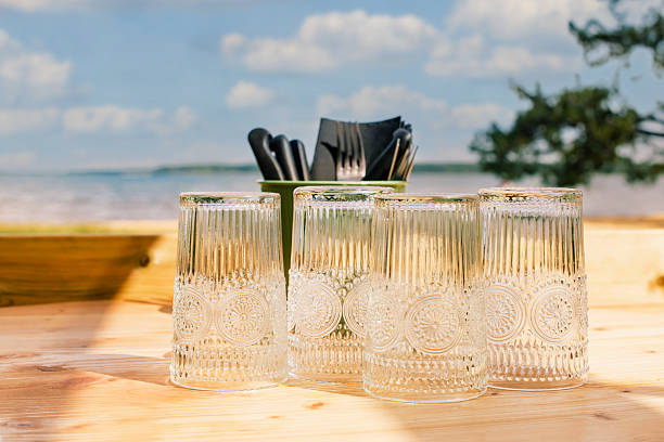 istock Restaurant or camping table with glasses placed on a wooden table facing the sea 2219193483