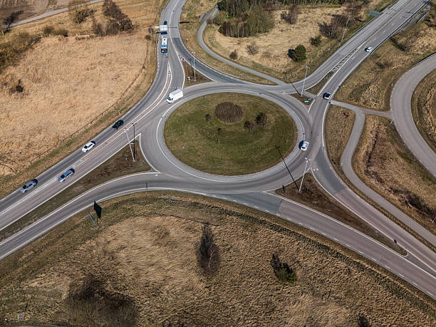 istock Busy traffic roundabout with multiple cars from aerial view.. 2219198213