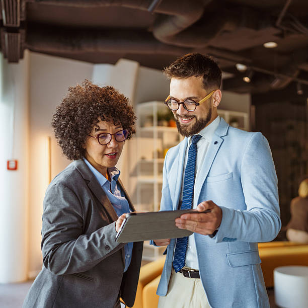 istock male and female colleagues use tablet together and discuss work 2219203658