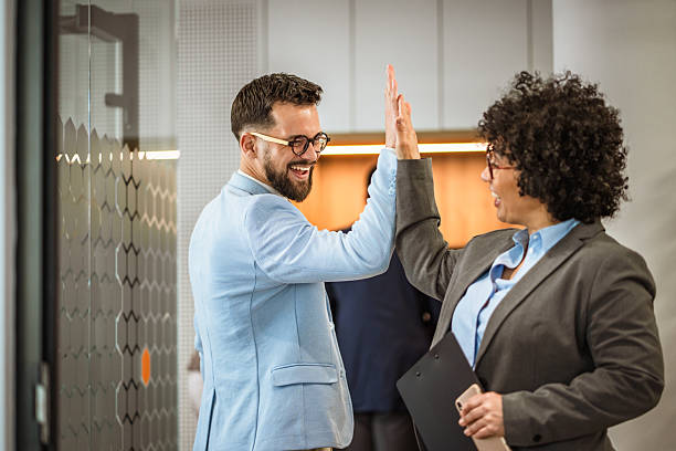 istock Happy diverse colleagues celebrating success with a lively high five 2219203705