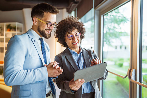 istock male and female colleagues use tablet together and discuss work 2219204068
