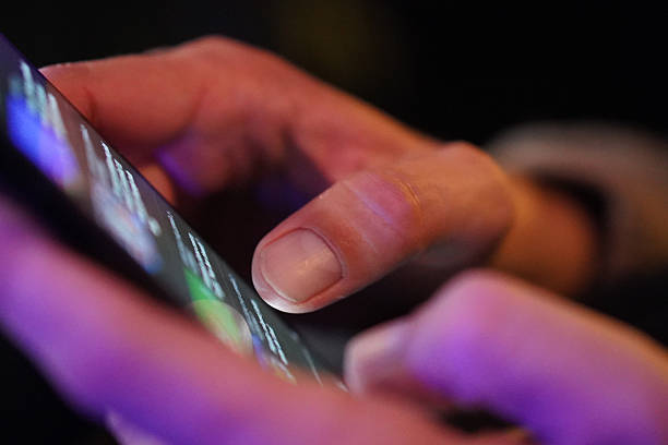 istock Person browsing social media on smartphone in a bar at night 2219205730