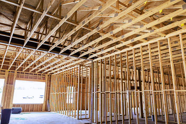 istock Construction of new building interior showing wooden framing, ceiling structure, open layout under natural light 2219207284