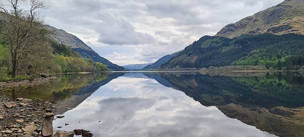 istock Serene Reflection of Scottish Highlands in Tranquil Lake 2219208216