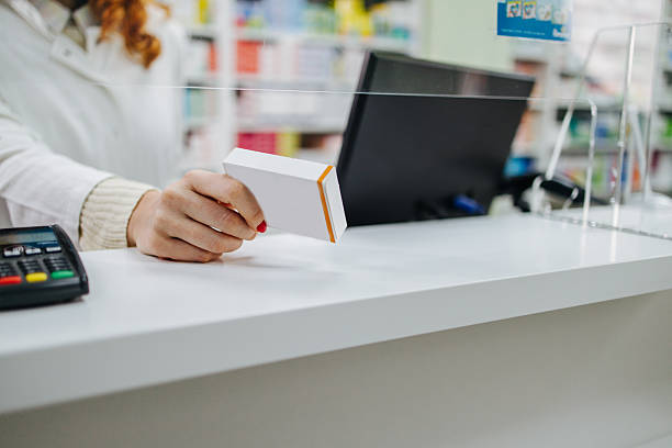 istock Pharmacist holding medicine box at pharmacy counter 2219208956