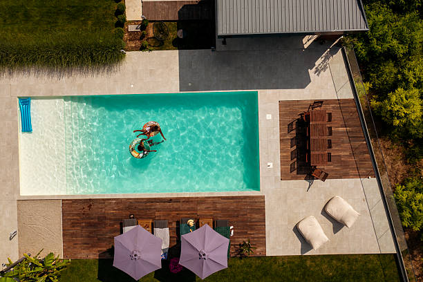 istock Drone Image of Couple Enjoying Poolside Moment 2219210518