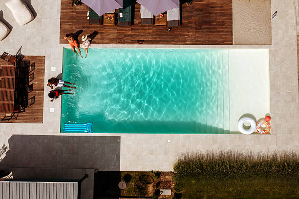 istock Top Down Drone View of Adults in Pool Having Fun on a Hot Day 2219210521