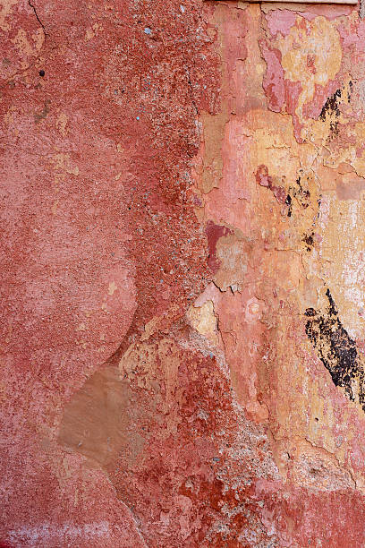 istock Wall with red worn and peeling paint and a tile with the number eleven, Genoa 2219211775