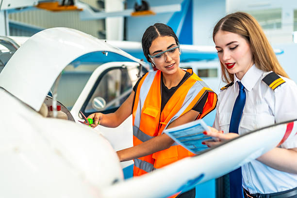 istock Female pilot and aircraft maintenance engineer performing pre-flight check 2219217201